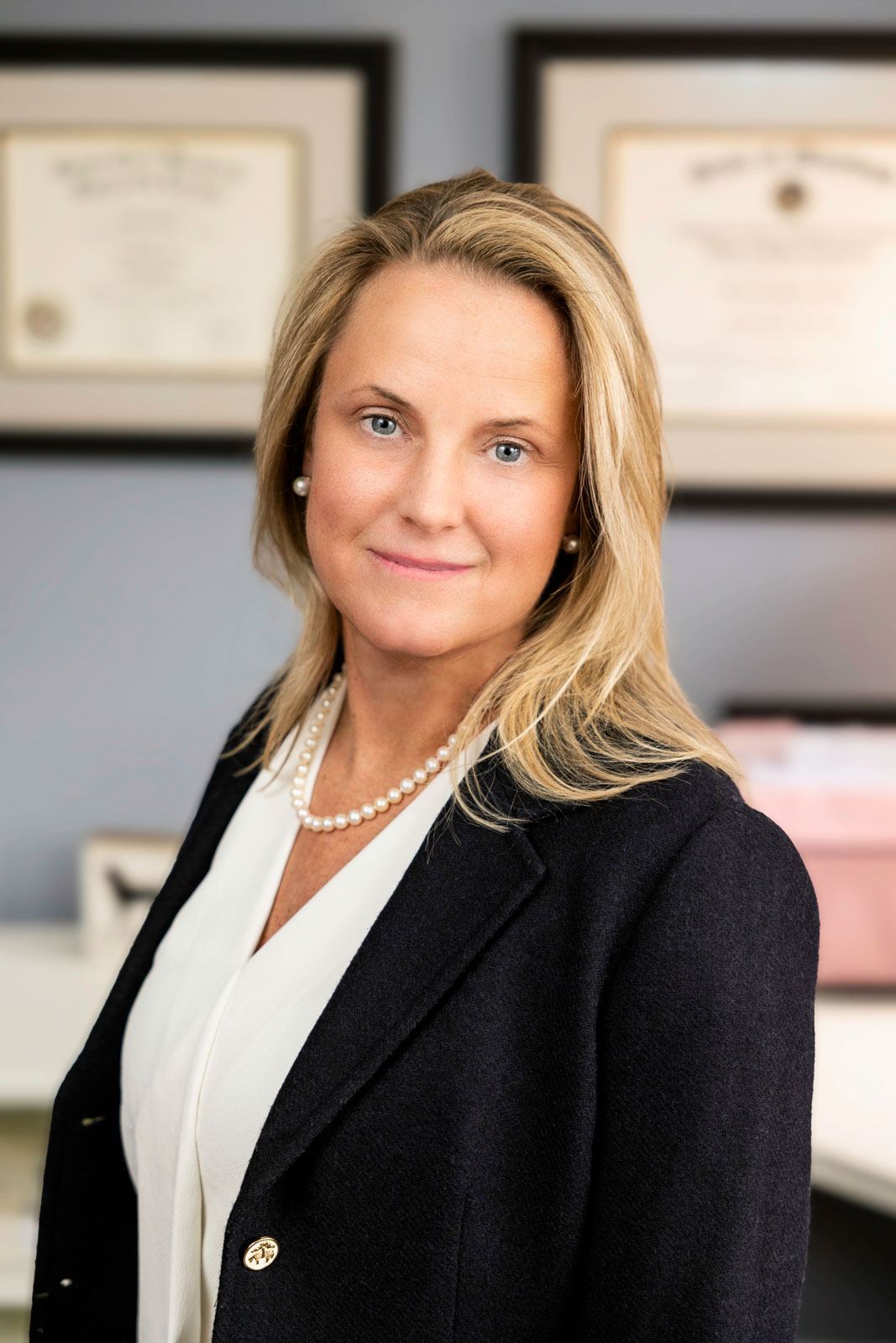 About 1 blonde woman in office wear and blazer